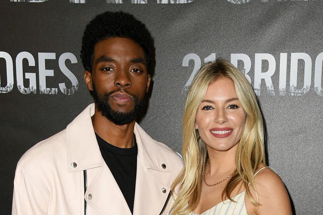 Chadwick Boseman and Sienna Miller at a '21 Bridges' premiere in November 2019