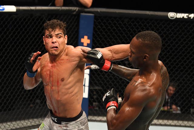 Israel Adesanya (right) retained his middleweight title by finishing Paulo Costa