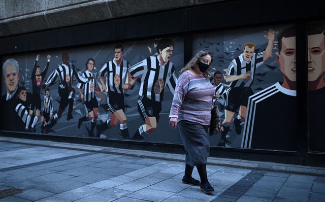 Woman wearing a face mask in Newcastle, where tighter regulations are coming in on 30 September