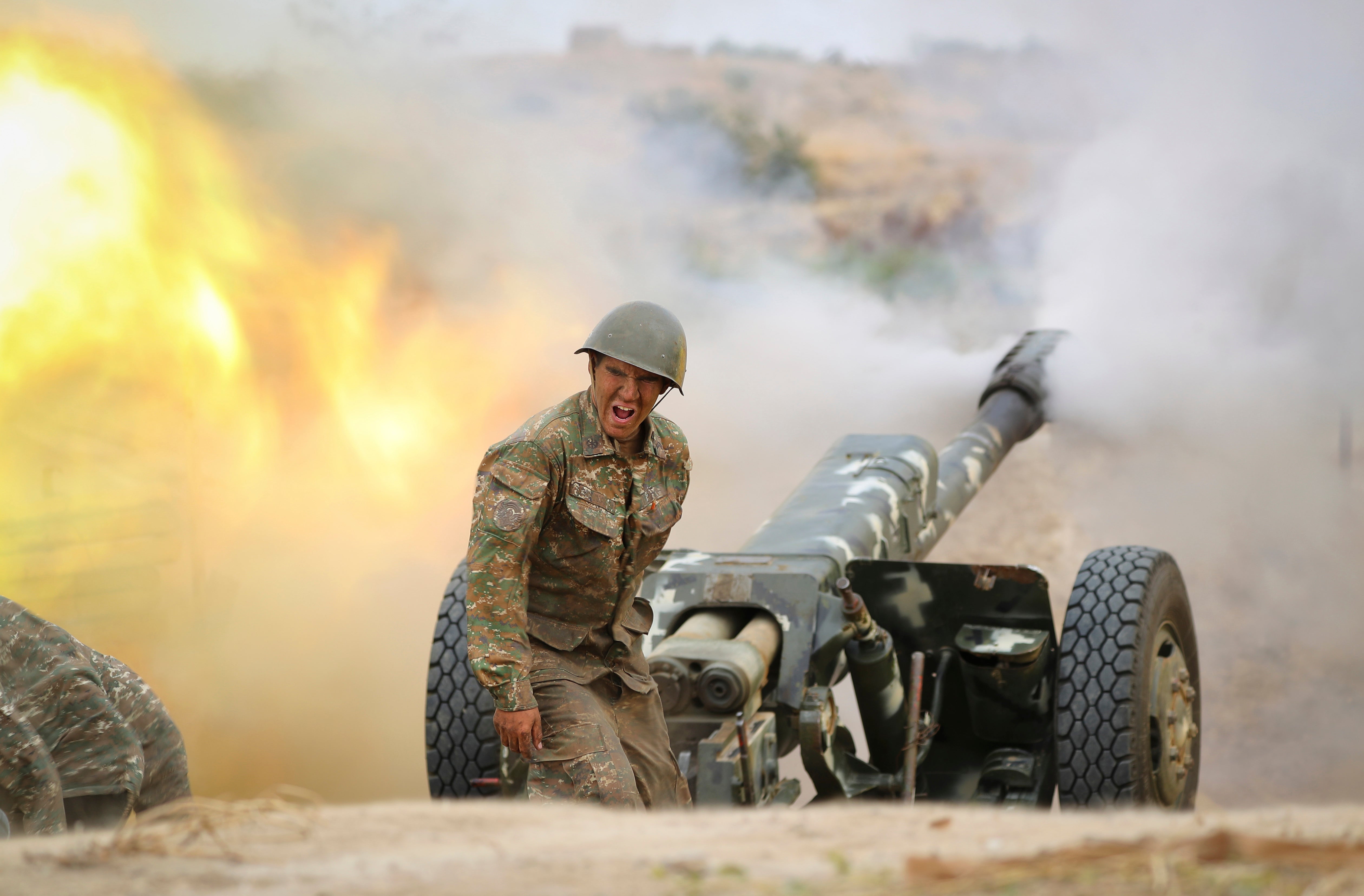 An Armenian serviceman fires a cannon towards Azerbaijan positions in the Nagorno-Karabakh region