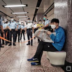 Hong Kong police cordon off passenger for reading pro-democracy newspaper on metro