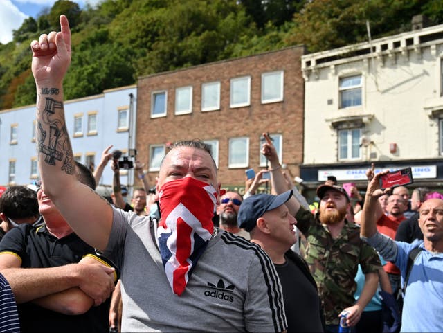 Anti-immigration protesters gesture as they block a main road in Dover on the south-east coast of England, on September 5, 2020