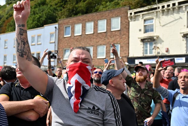 Anti-immigration protesters gesture as they block a main road in Dover on the south-east coast of England, on September 5, 2020