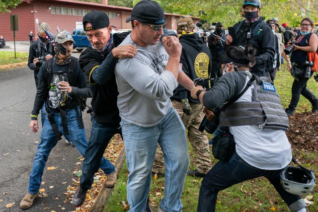 A Proud Boys member pulls away another who was assaulting a freelance journalist in Portland, Oregon, last week.