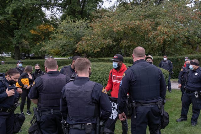 White Cleveland police officers stop a black man selling t-shirts in Wade Park, Ohio, on 29 September