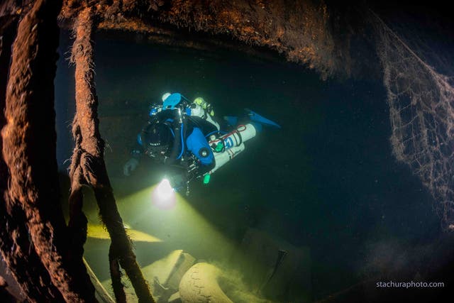 A diver checks the wreck of a German Second World War ship "Karlsruhe" during a search operation in the Baltic sea in June 2020