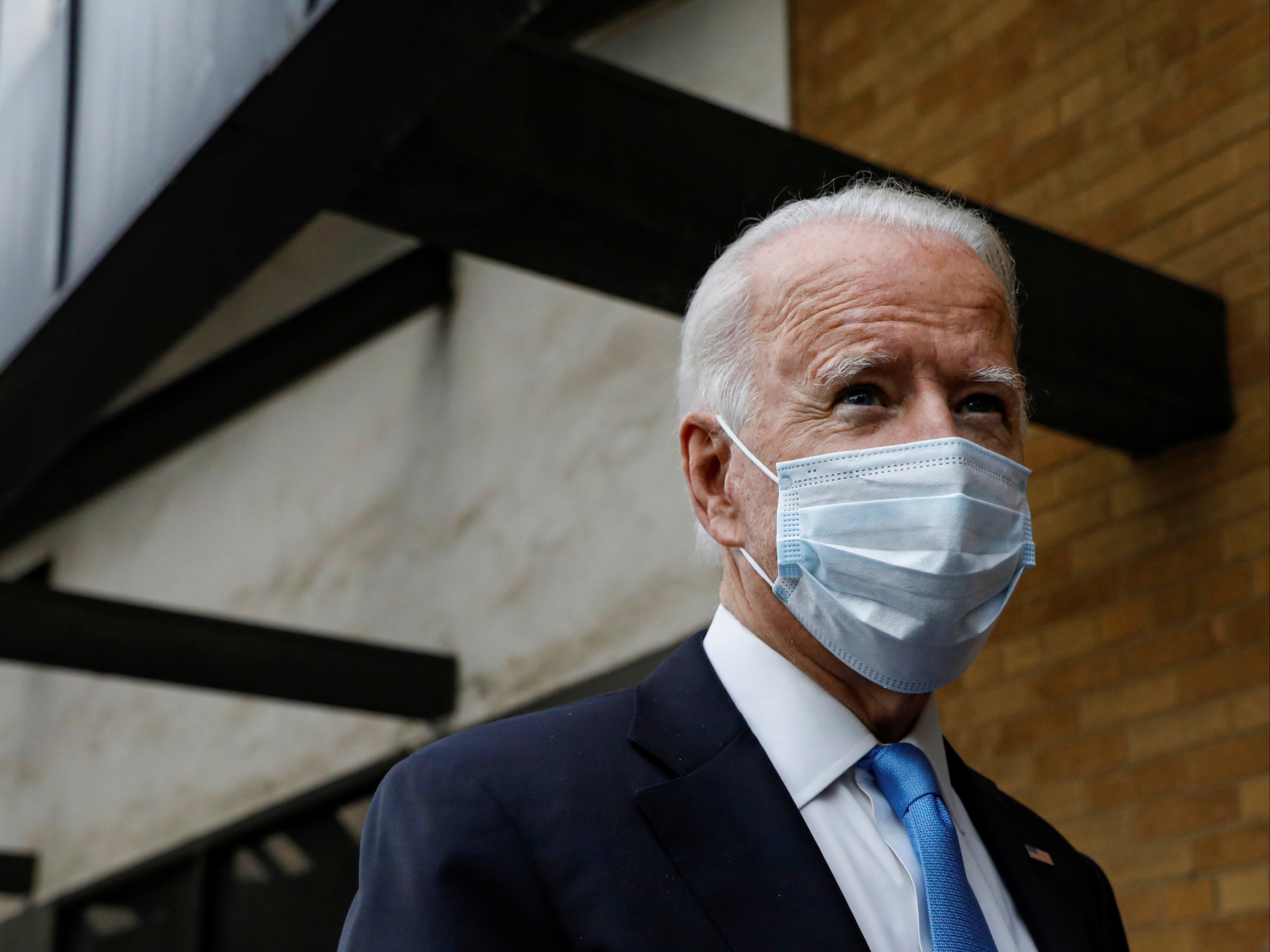 US Democratic presidential candidate and former Vice President Joe Biden stops to answer questions as he exits The Queen theatre in Wilmington, Delaware