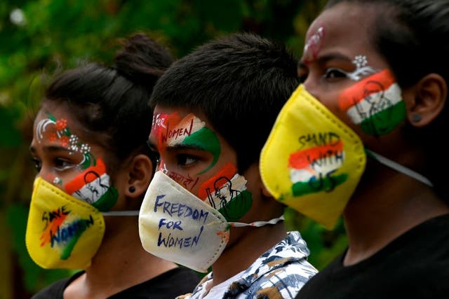 Indian students paint their faces to condemn the gang-rape of a 19-year-old woman in Bool Garhi village