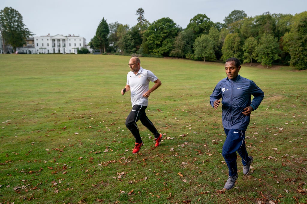 Kenenisa Bekele trains alongside his coach Peter Eemers within the grounds of the bubble