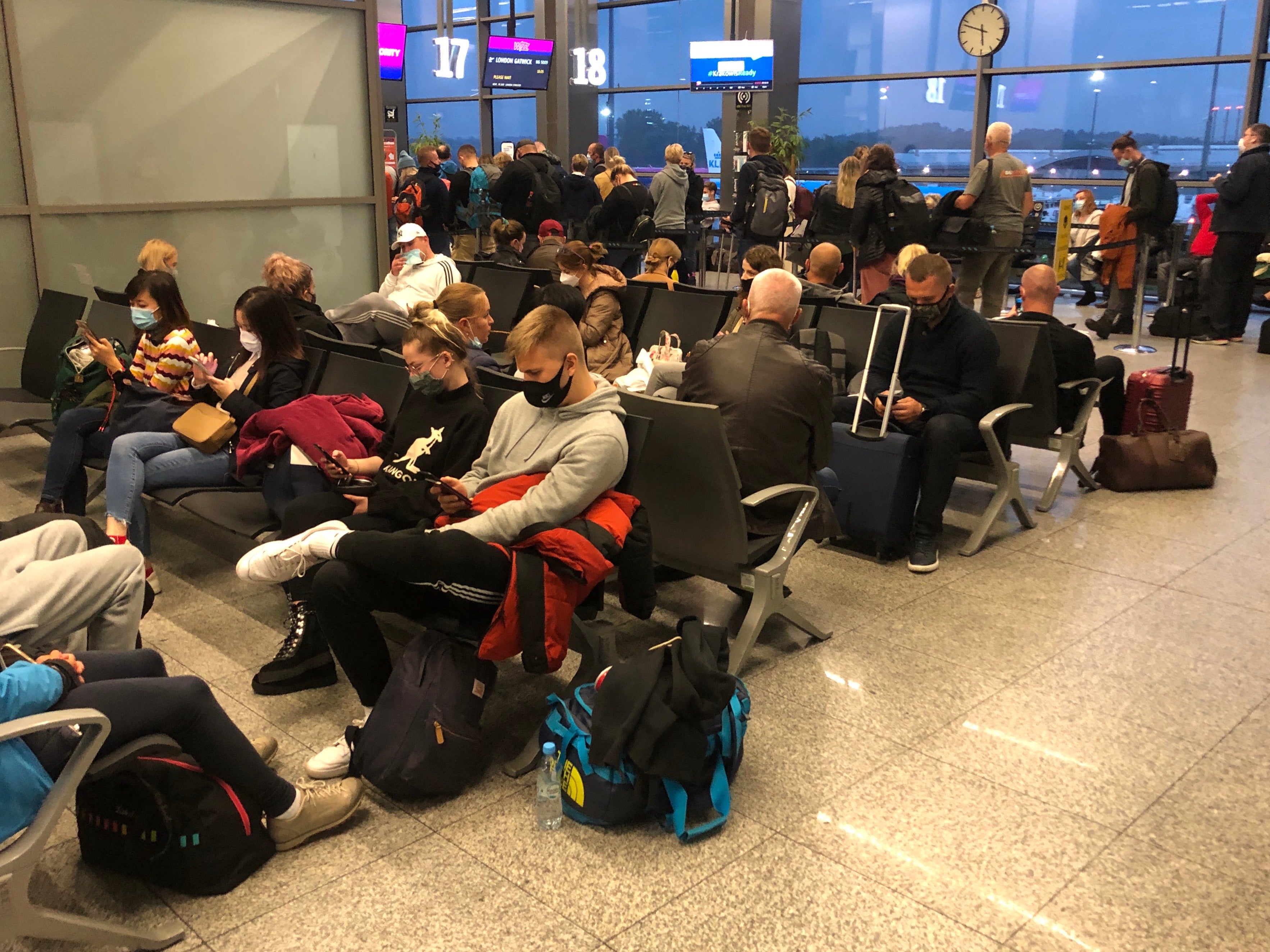 Waiting game: Wizz Air passengers at Krakow airport in Poland before the quarantine deadline