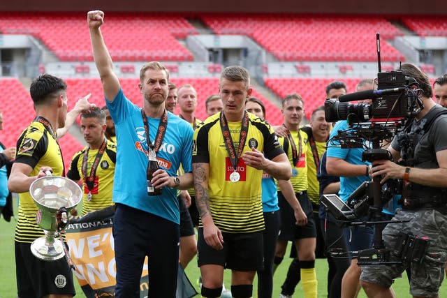 Harrogate Town coach Simon Weaver celebrates promotion to the Football League with his players