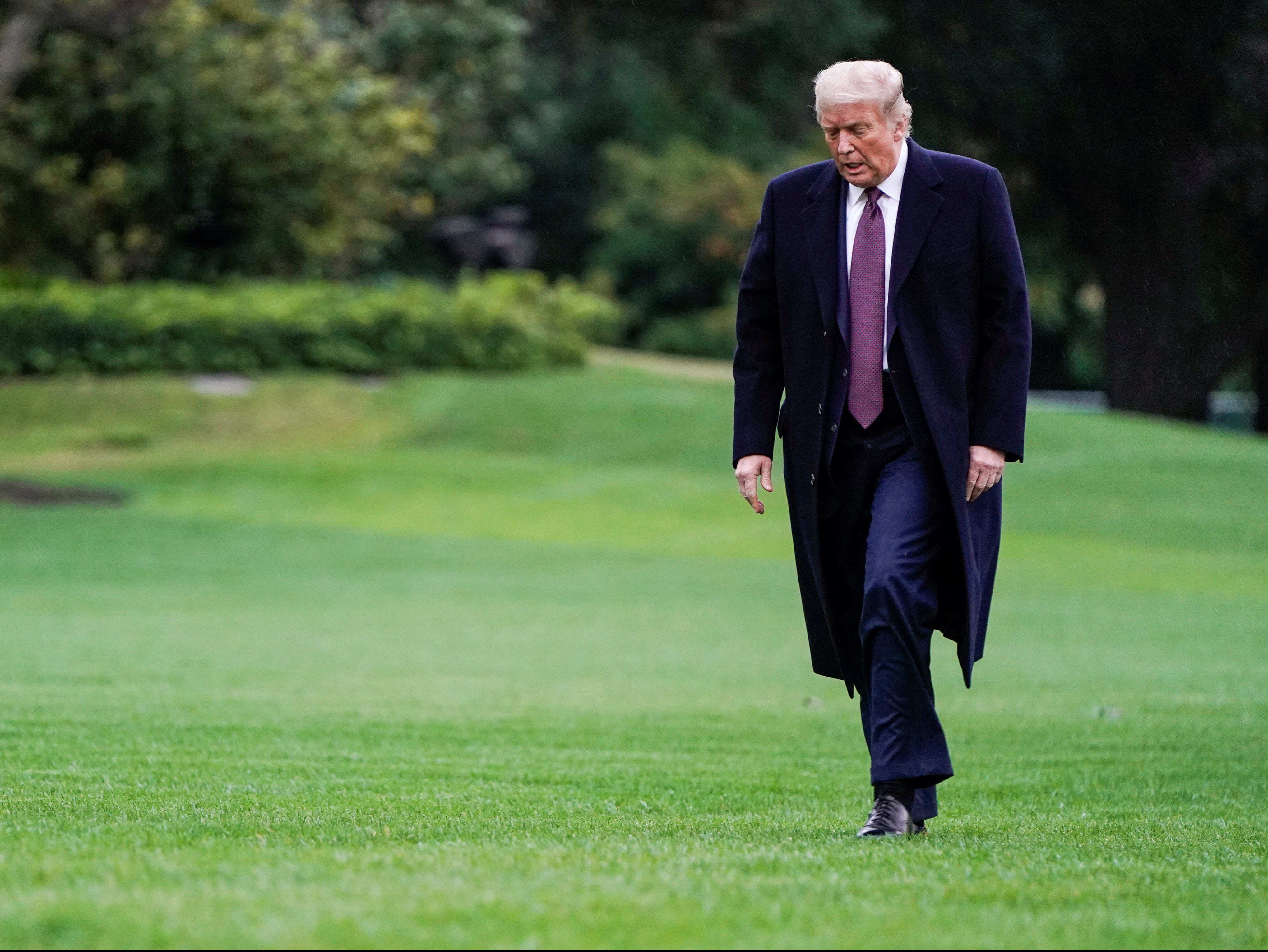 Donald Trump walks from Marine One as he returns from Bedminster, New Jersey