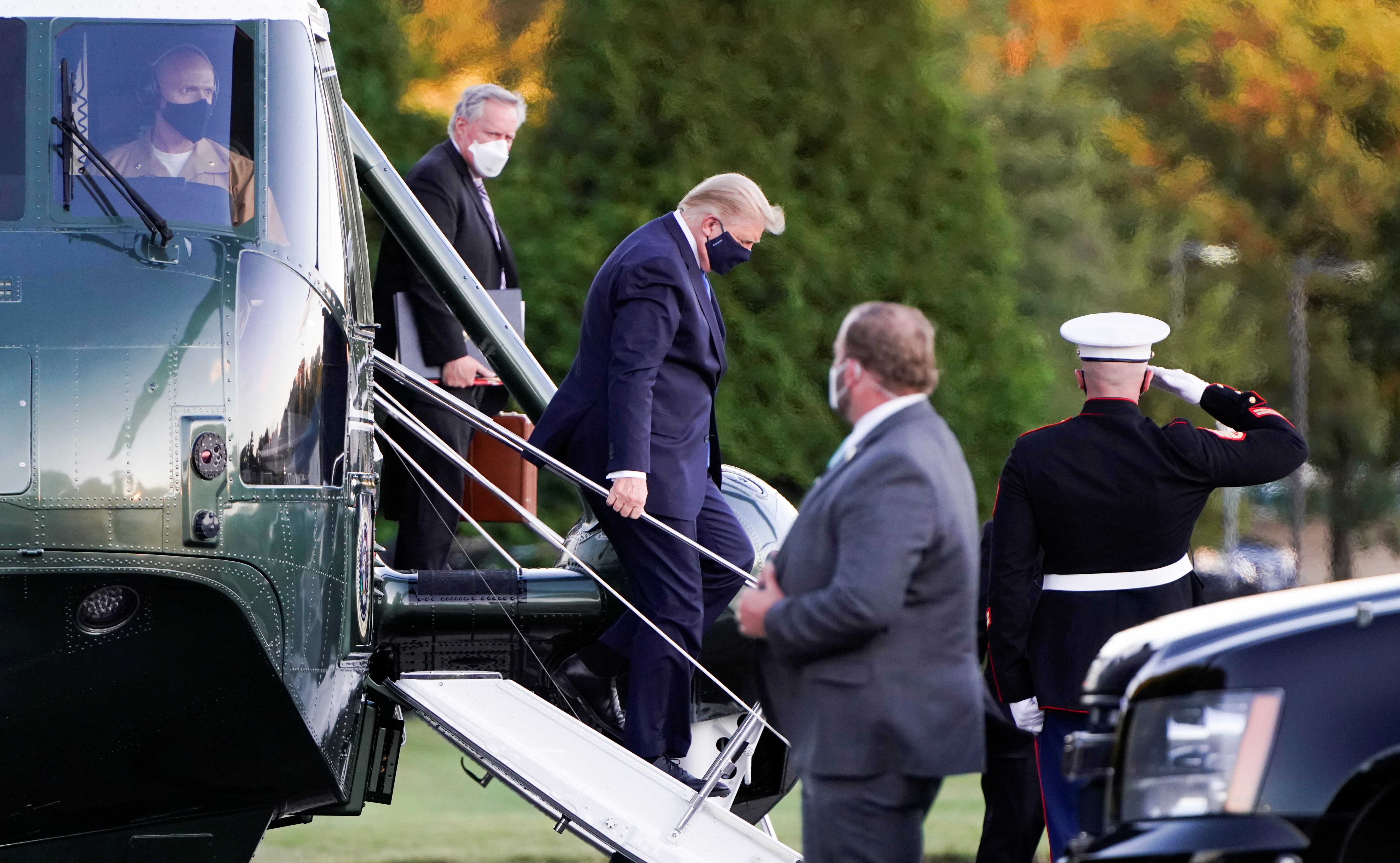 U.S. President Donald Trump disembarks from the Marine One helicopter followed by White House Chief of Staff Mark Meadows as he arrives at Walter Reed National Military Medical Center after the White House announced that he "will be working from the presidential offices at Walter Reed for the next few days" after testing positive for the coronavirus disease (COVID-19), in Bethesda, Maryland, U.S., October 2, 2020.  REUTERS/Joshua Roberts