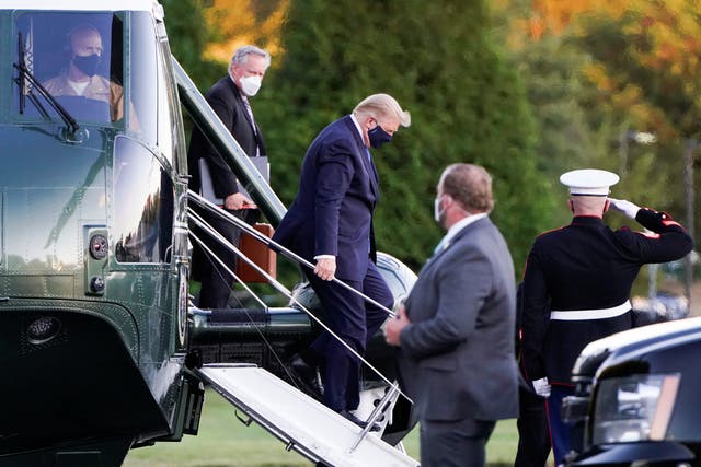 U.S. President Donald Trump disembarks from the Marine One helicopter followed by White House Chief of Staff Mark Meadows as he arrives at Walter Reed National Military Medical Center after the White House announced that he "will be working from the presidential offices at Walter Reed for the next few days" after testing positive for the coronavirus disease (COVID-19), in Bethesda, Maryland, U.S., October 2, 2020.  REUTERS/Joshua Roberts