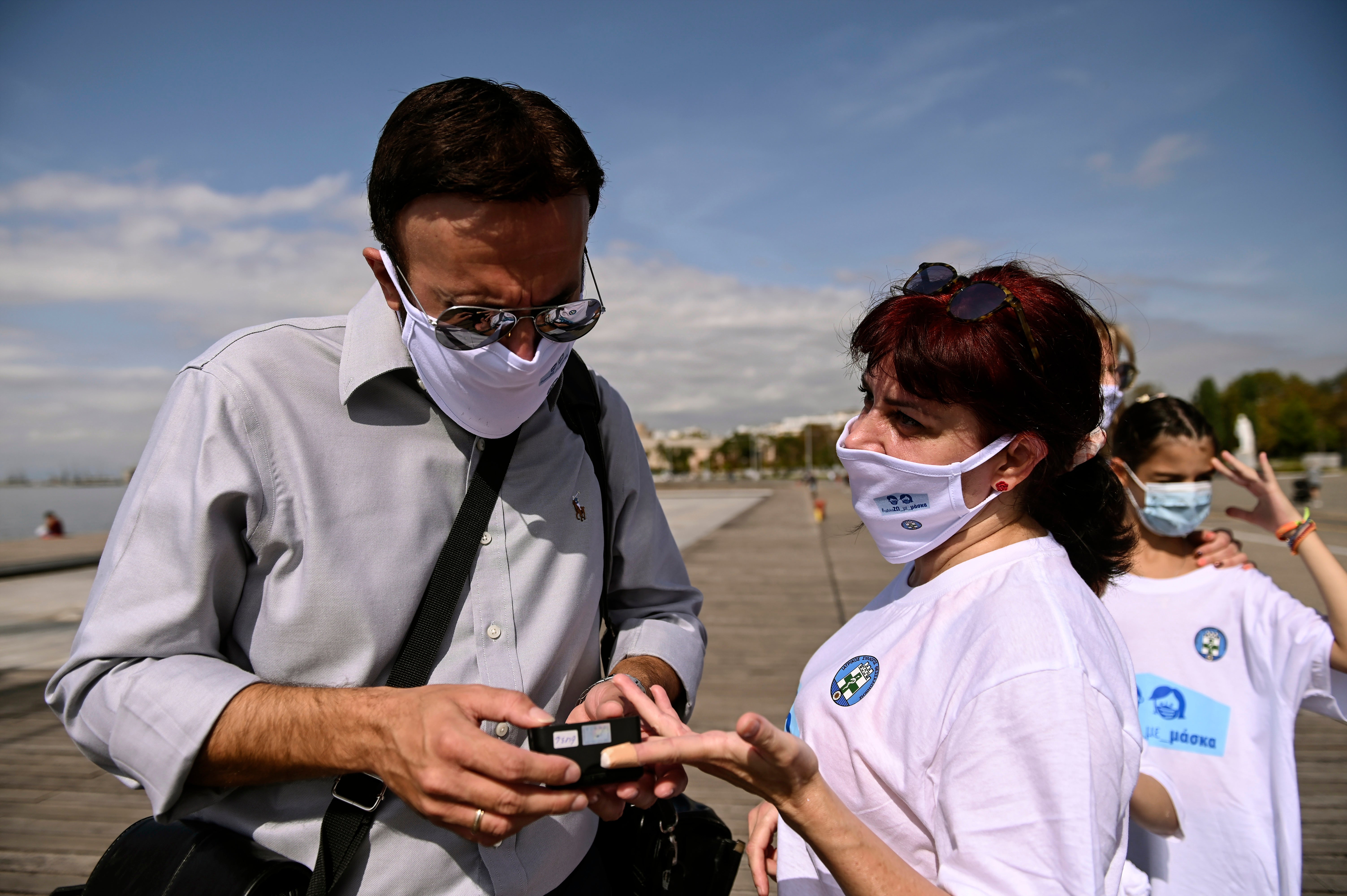 Greek doctors march and measure to promote use of face masks People