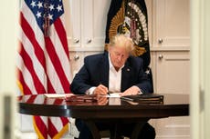 Trump mocked for signing apparently blank paper in ‘staged’ photos at Walter Reed