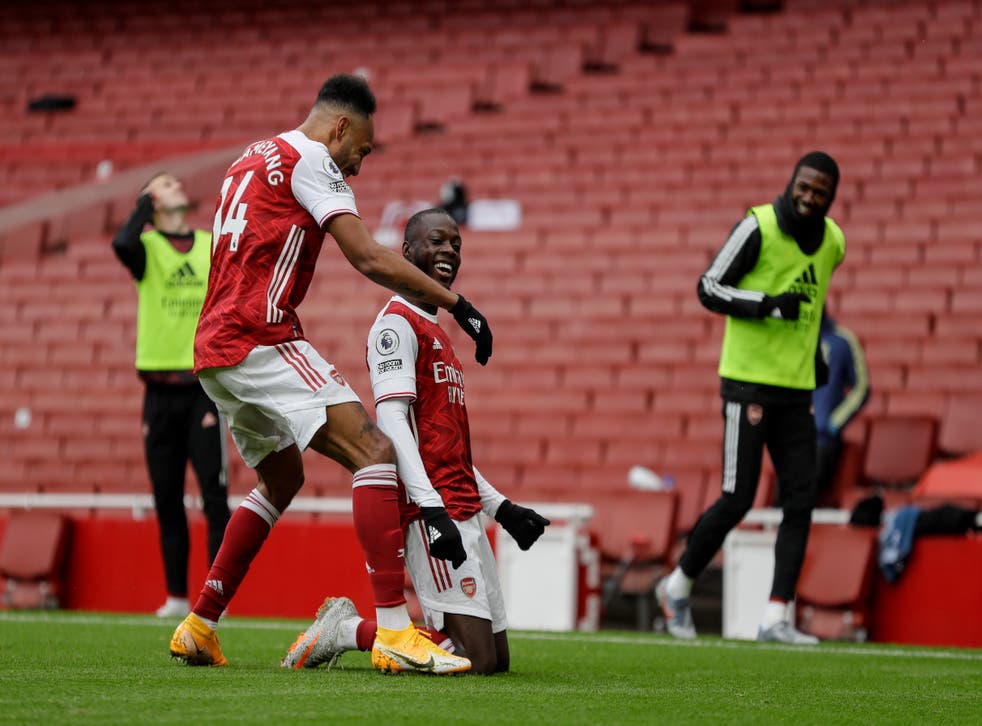 Nicolas Pepe celebrates with Pierre-Emerick Aubameyang after scoring the goal to secure Arsenal victory