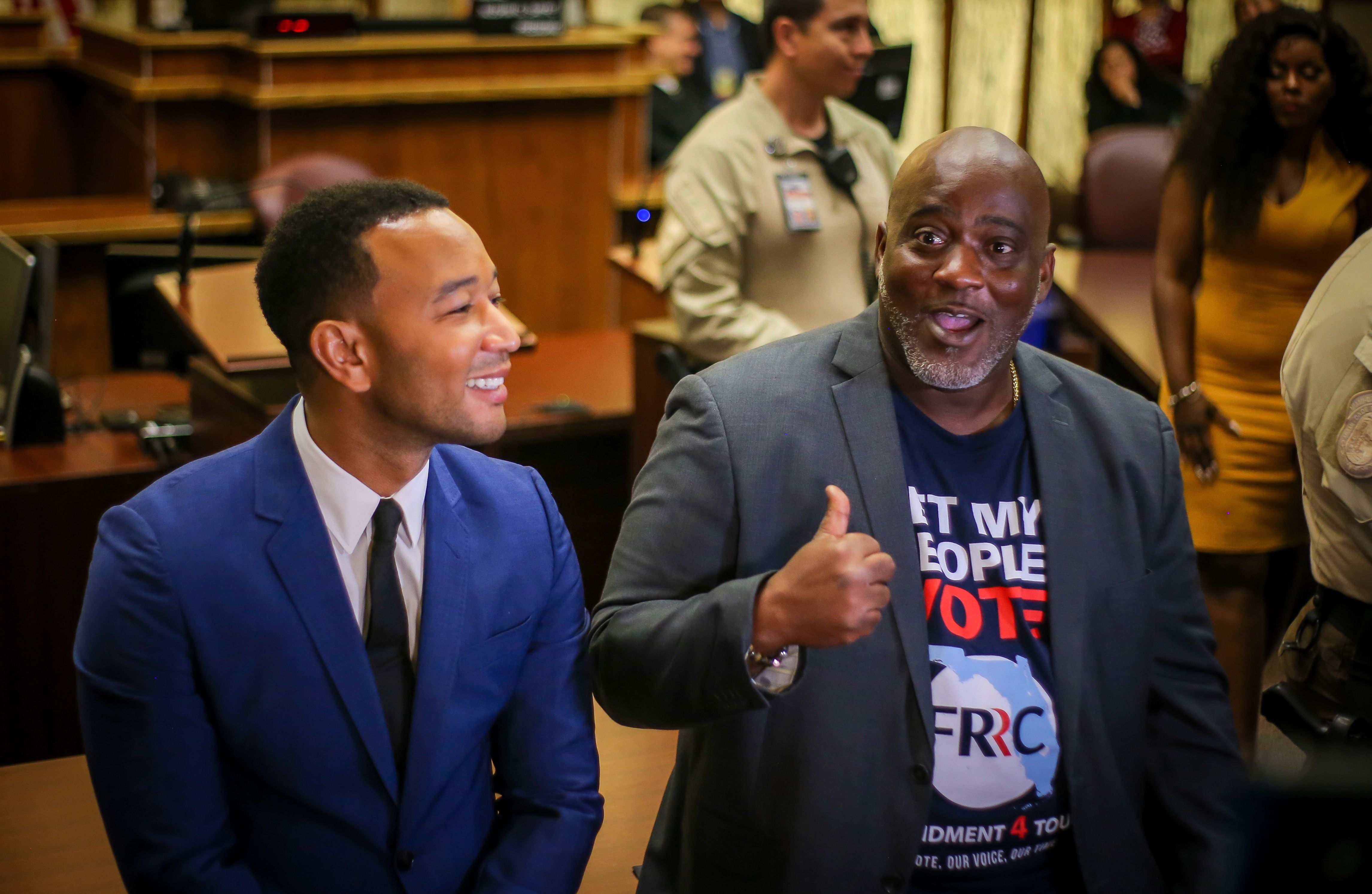 Singer songwriter John Legend (left) and president of the Florida Rights Restoration Coalition Desmond Meade speak to reporters after a court hearing aimed at restoring the right to vote under Florida's Amendment 4