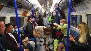 People on a Northern Line train in London, after the 10pm curfew pubs and restaurants are subject to in order to combat the rise in coronavirus cases in England