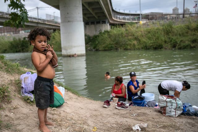 Asylum seekers wash clothes in river by Matamoros camp on 8 Dec 2019 - At least 50 percent of the asylum seekers still waiting at the camp are children under the age of 15