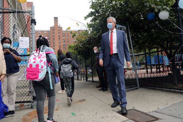 <p>Bill de Blasio , the mayor of New York, stands outside a school welcoming back students in September. Now he warns closing the schools is likely</p><p>&nbsp;</p>