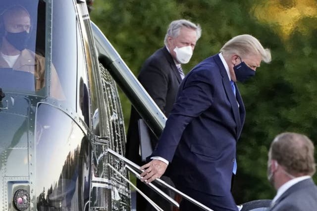 Donald Trump, seen here arriving at Walter Reed military hospital on Friday, says he will return to the White House on Monday evening. 
