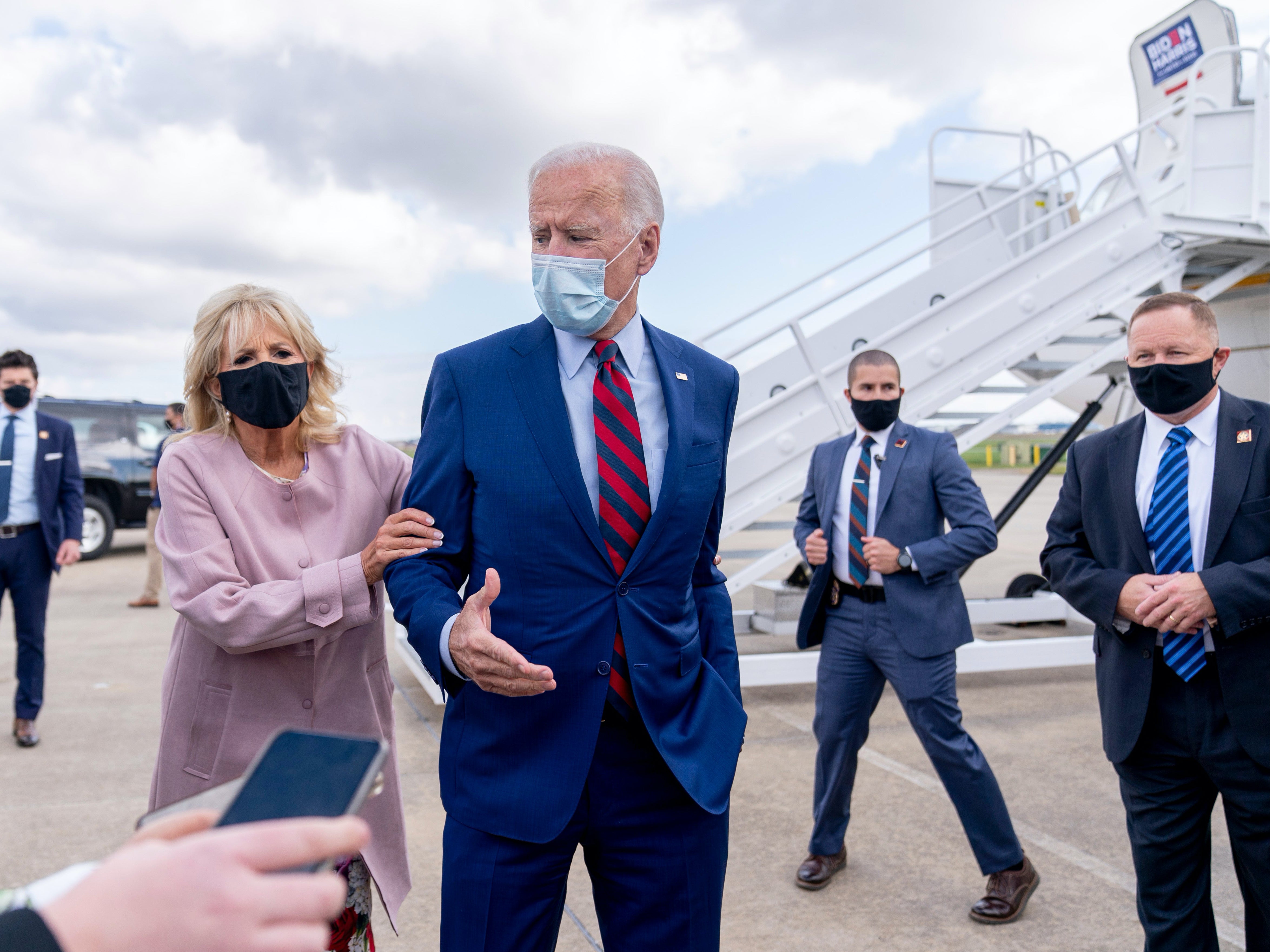 Former Vice President Joe Biden talks to reporters before a flight to Florida for campaigning.