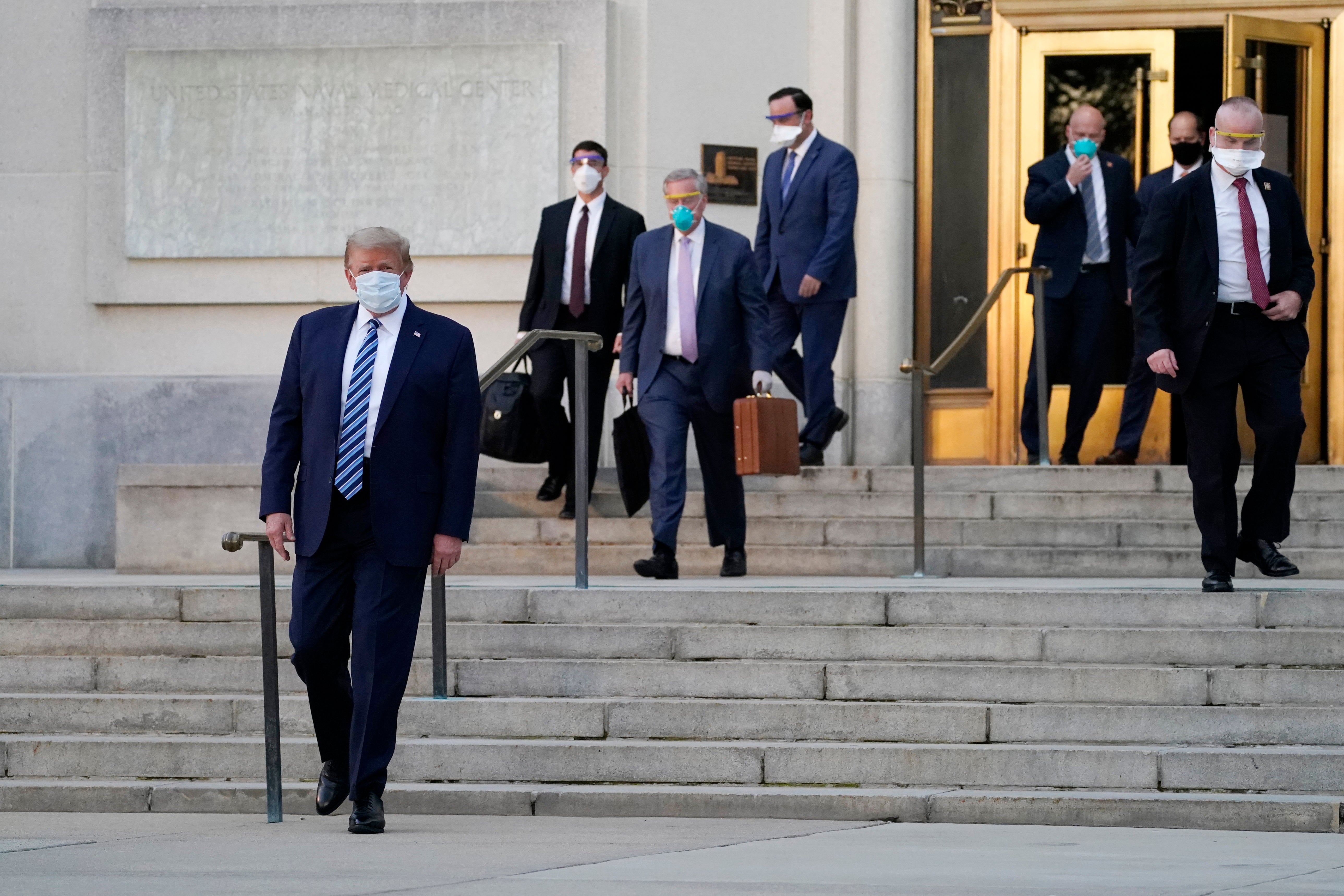 <p>Donald Trump walks out of Walter Reed medical centre following his hospitalisation from the coronavirus.</p>
