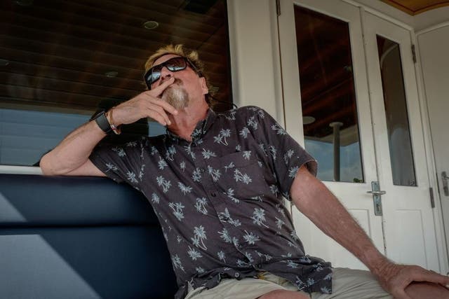 John McAfee gestures during an interview on a yacht anchored at the Marina Hemingway in Havana, on 26 June, 2019