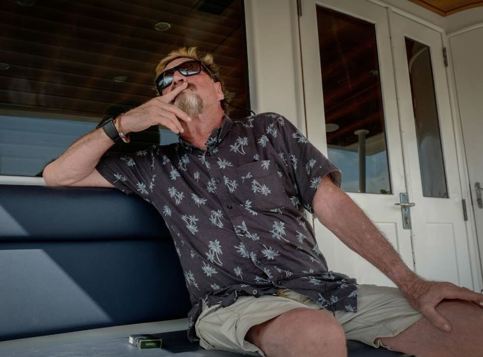 John McAfee gestures during an interview on a yacht anchored at the Marina Hemingway in Havana, on 26 June, 2019
