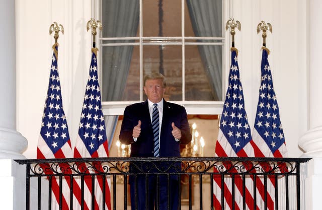 Donald Trump gives the thumbs up after returning to the White House from hospital