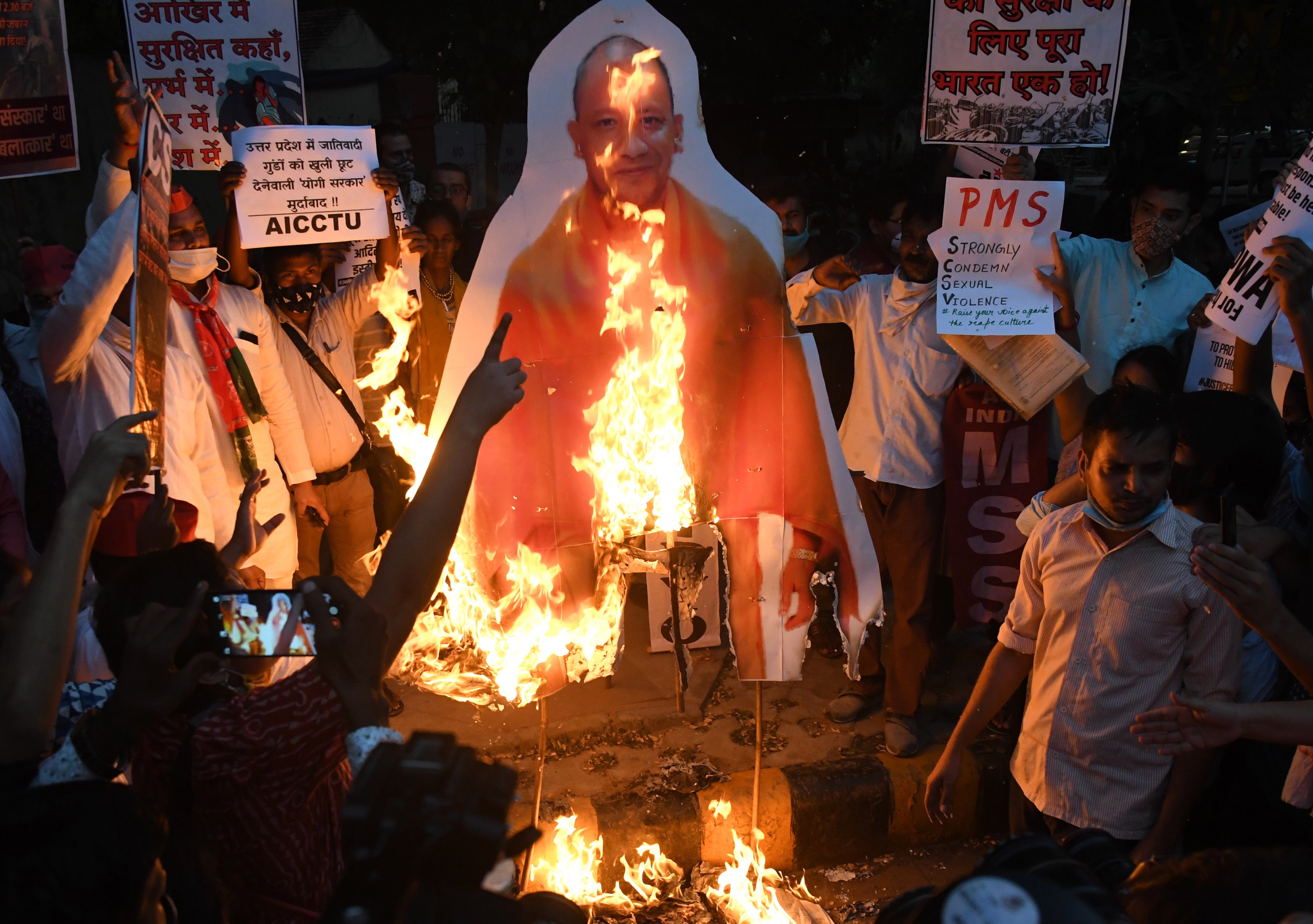Students of JNU in Delhi burn a cut-out of the Uttar Pradesh chief minister Yogi Adityanath on Monday