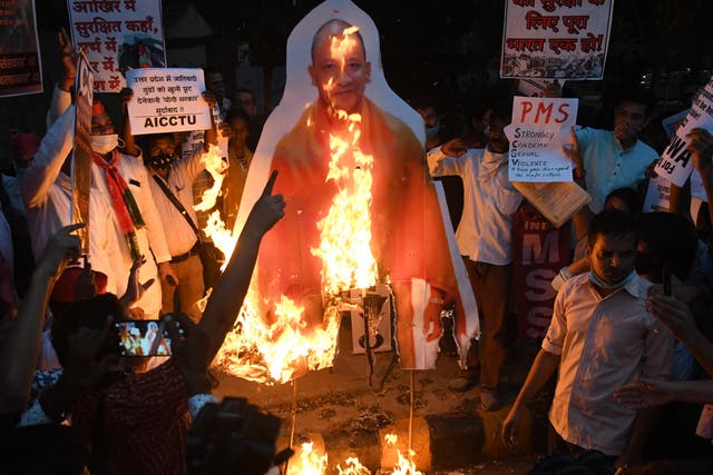Students of JNU in Delhi burn a cut-out of the Uttar Pradesh chief minister Yogi Adityanath on Monday