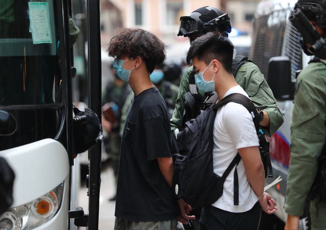 Hong Kong police bundle pro-independent activists into a van
