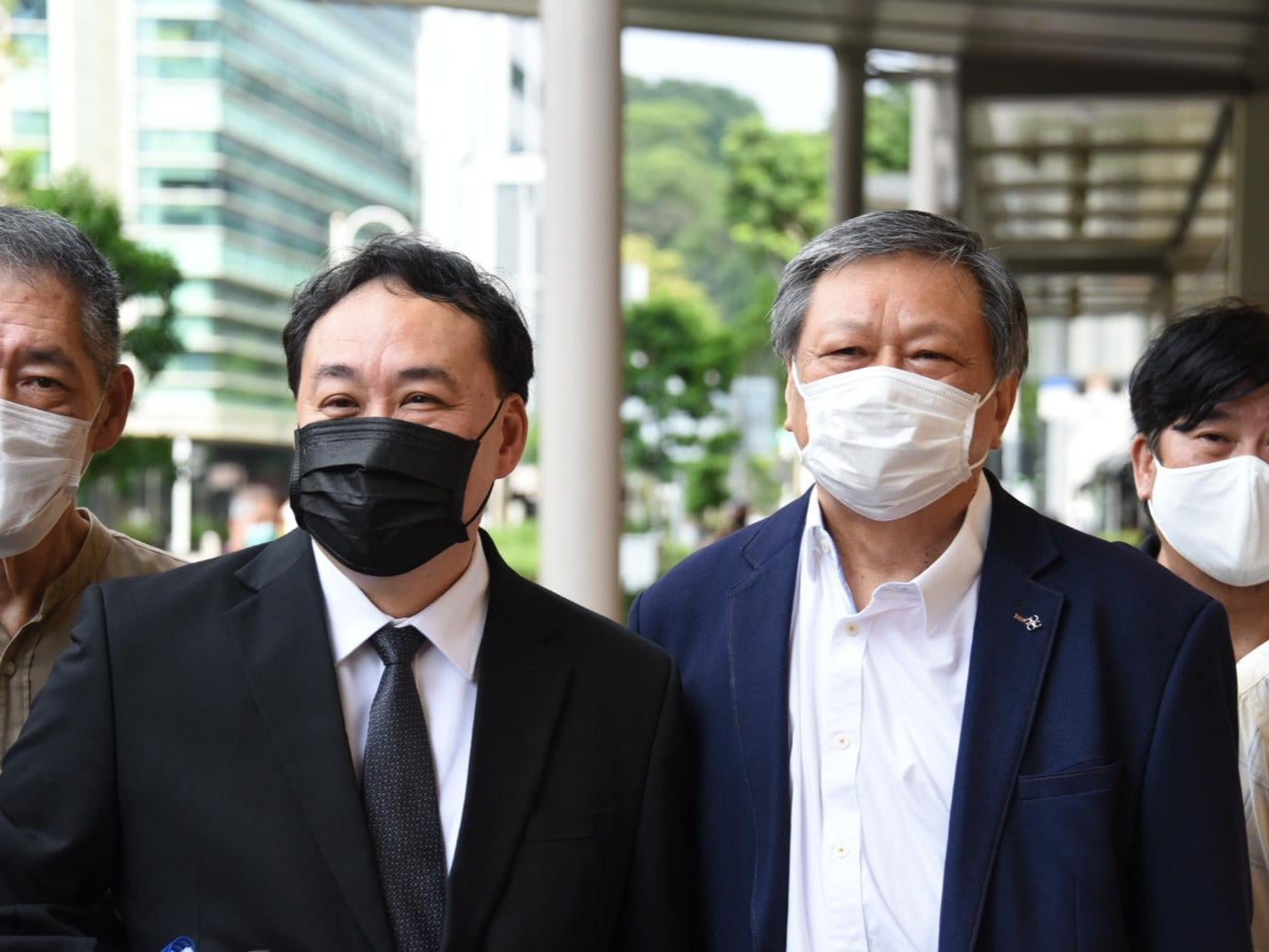Writer Leong Sze Hian (centre right) and his lawyer Lim Tean (centre left) arrive at the High Court on Tuesday