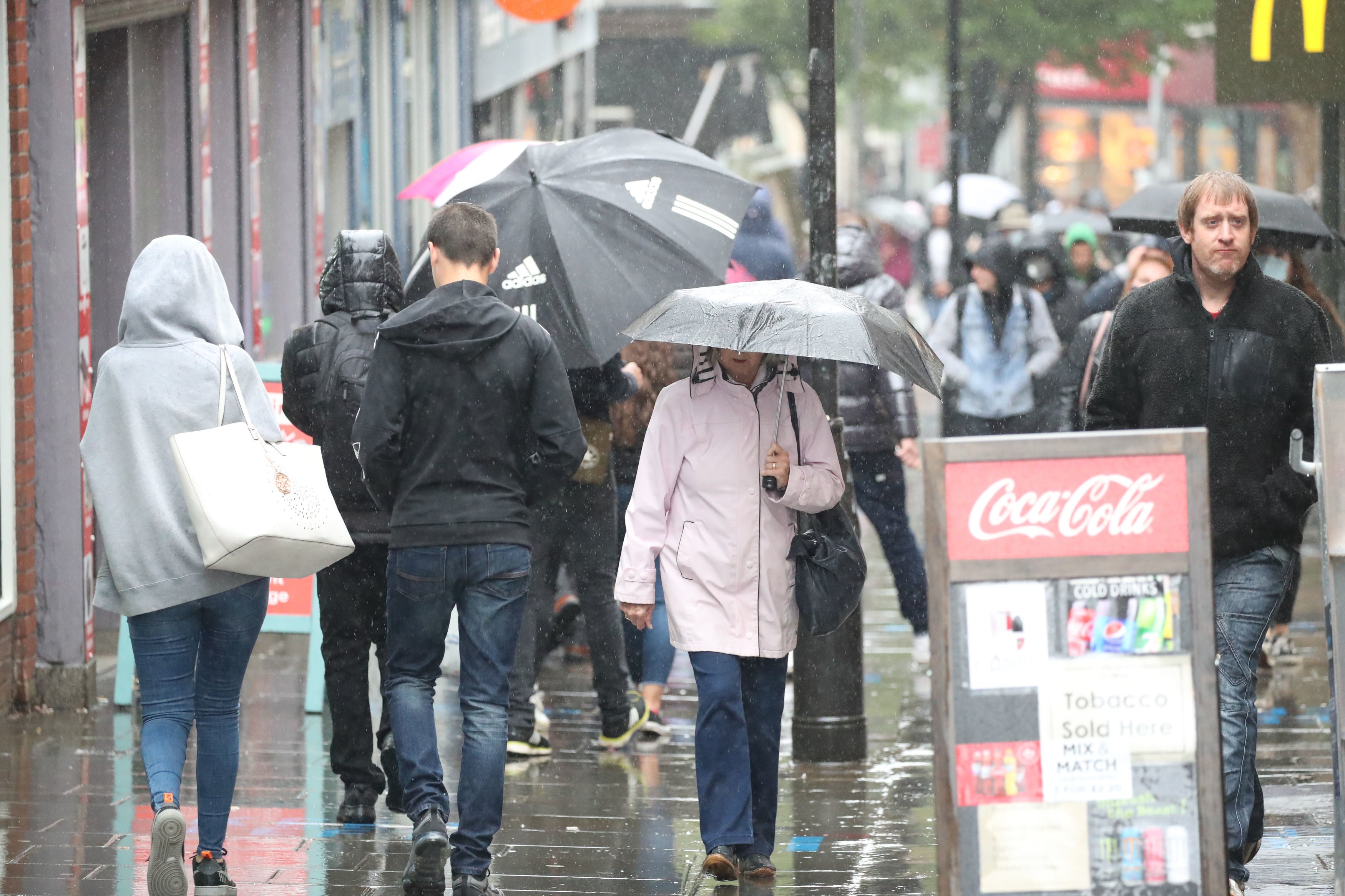 People walk through central Nottingham in the rain on 3 October, 2020.