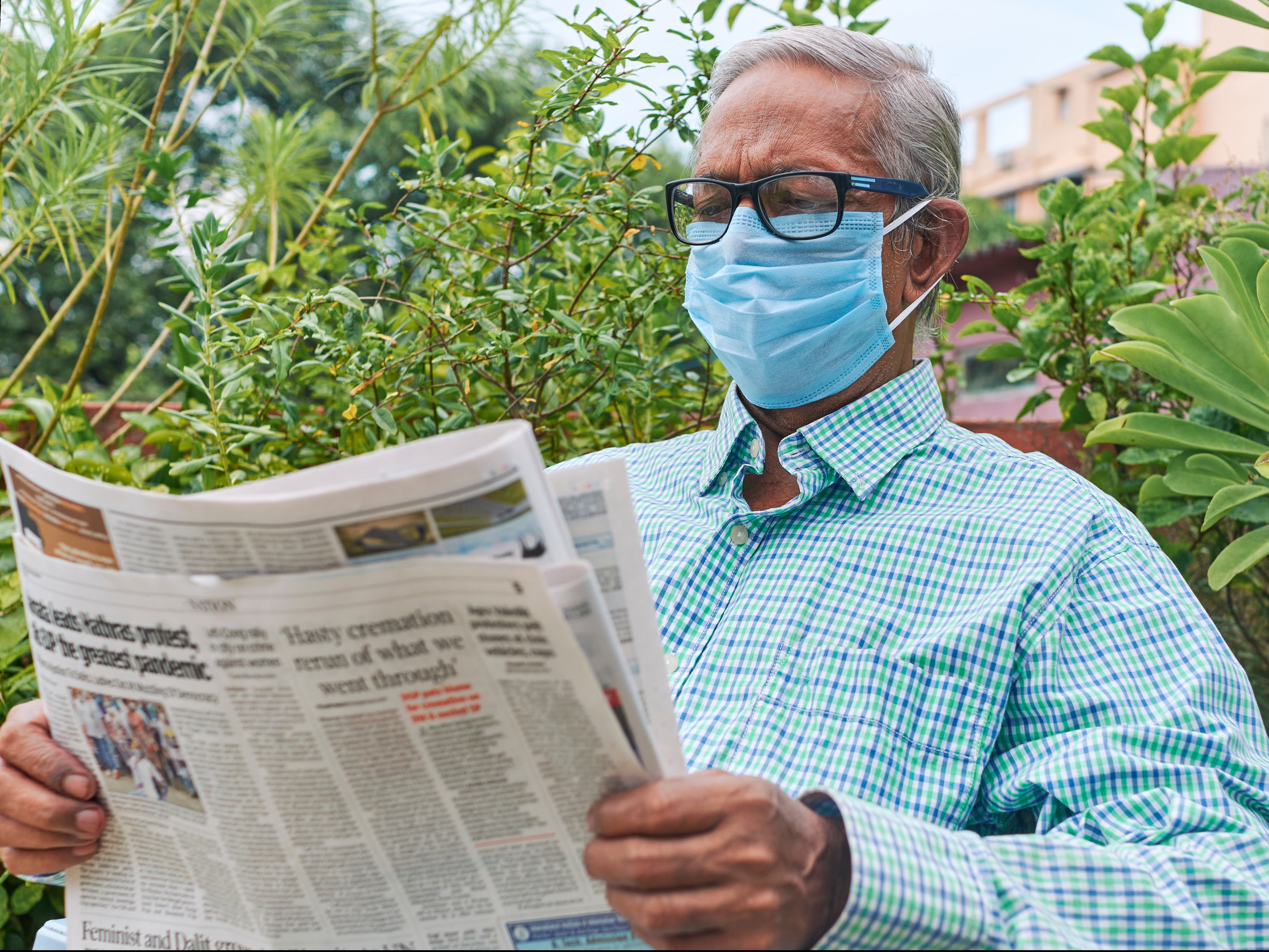 A man reads a newspaper during the coronavirus pandemic.