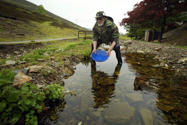 Gold panner Eric Gray-Thomas of Wales tries his hand at searching for gold in a burn May 29, 2004 in Wanlockhead, Scotland. Prospectors from across Europe are taking part in the two-day British Gold Panning Competition in Wanlockhead, Scotland's highest village at 1531 feet (468 meters ) above sea level.