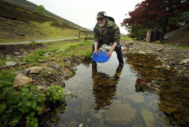 Gold panner Eric Gray-Thomas of Wales tries his hand at searching for gold in a burn May 29, 2004 in Wanlockhead, Scotland. Prospectors from across Europe are taking part in the two-day British Gold Panning Competition in Wanlockhead, Scotland's highest village at 1531 feet (468 meters ) above sea level.