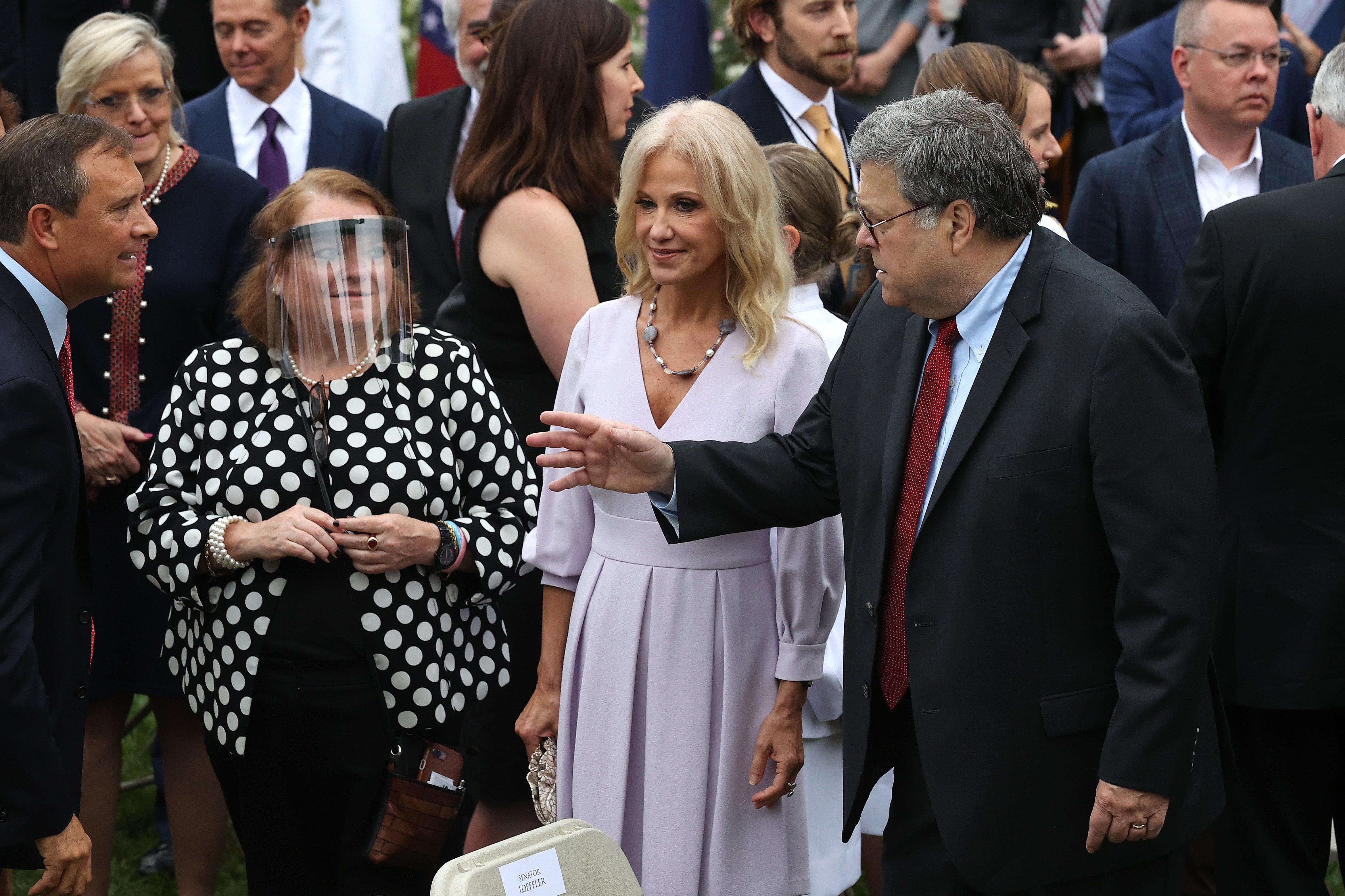 Kellyanne Conway and Attorney General William Barr talk with guests in the Rose Garden after President Donald Trump introduced Judge Amy Coney Barrett as his nominee to the Supreme Court