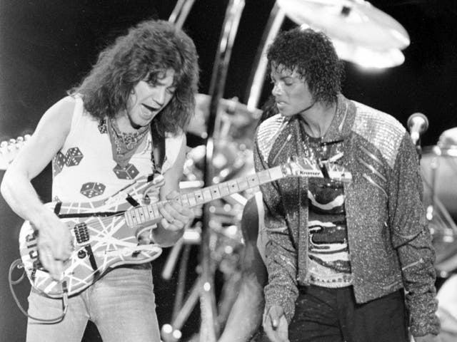This 14 July 1984 file photo shows Van Halen guitarist Eddie Van Halen, left, performing Beat It with Michael Jackson during Jackson’s Victory Tour concert in Irving, Texas. 