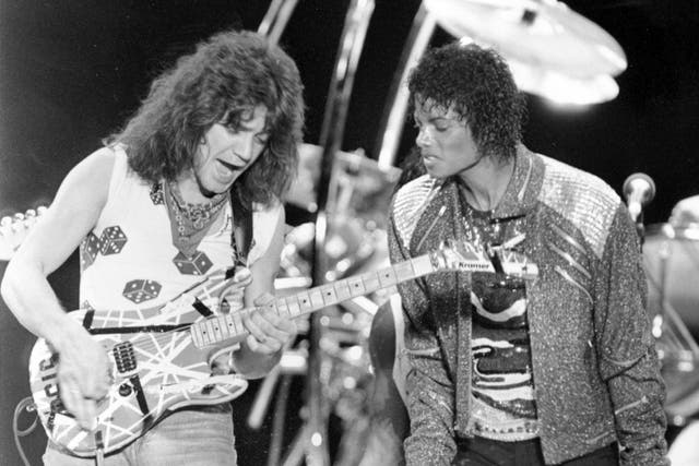This 14 July 1984 file photo shows Van Halen guitarist Eddie Van Halen, left, performing Beat It with Michael Jackson during Jackson’s Victory Tour concert in Irving, Texas. 