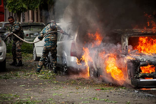 Firefighters tackle a burning car in Nagorno-Karabakh