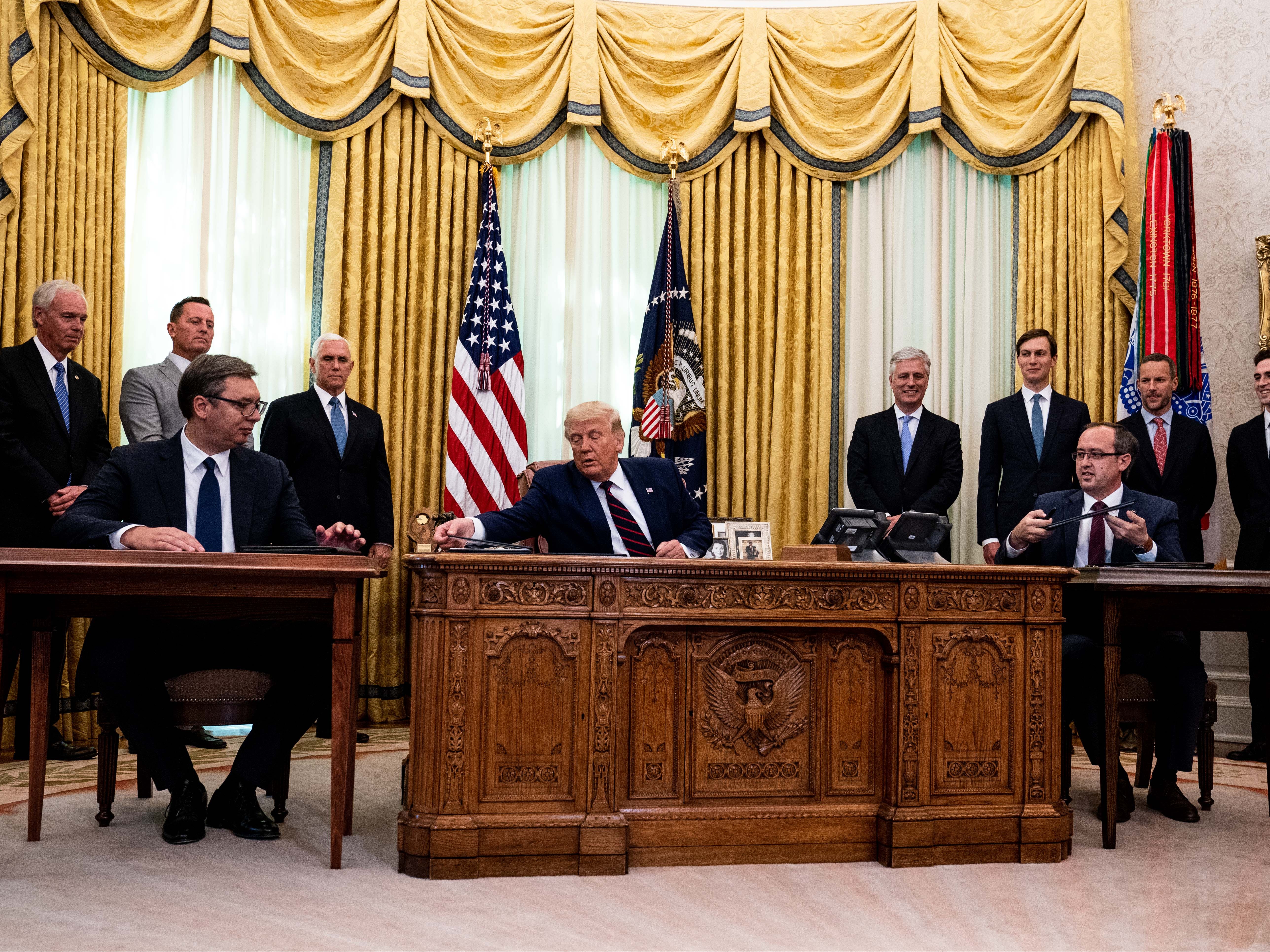 Donald Trump (centre) participates in a signing ceremony and meeting with Serbian president Aleksandar Vucic (left) and Kosovo prime minister Avdullah Hoti (right)