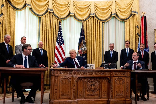 Donald Trump (centre) participates in a signing ceremony and meeting with Serbian president Aleksandar Vucic (left) and Kosovo prime minister Avdullah Hoti (right)