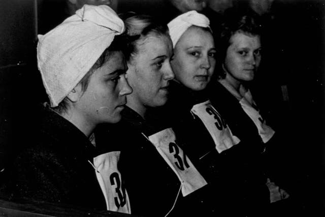 Four female guards photographed in the dock during the Belsen trial for concentration camp atrocities, in Luneburg