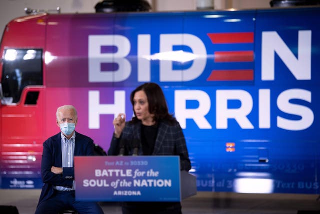 Democratic vice presidential candidate Kamala Harris speaks as her running mate, Joe Biden, look on.