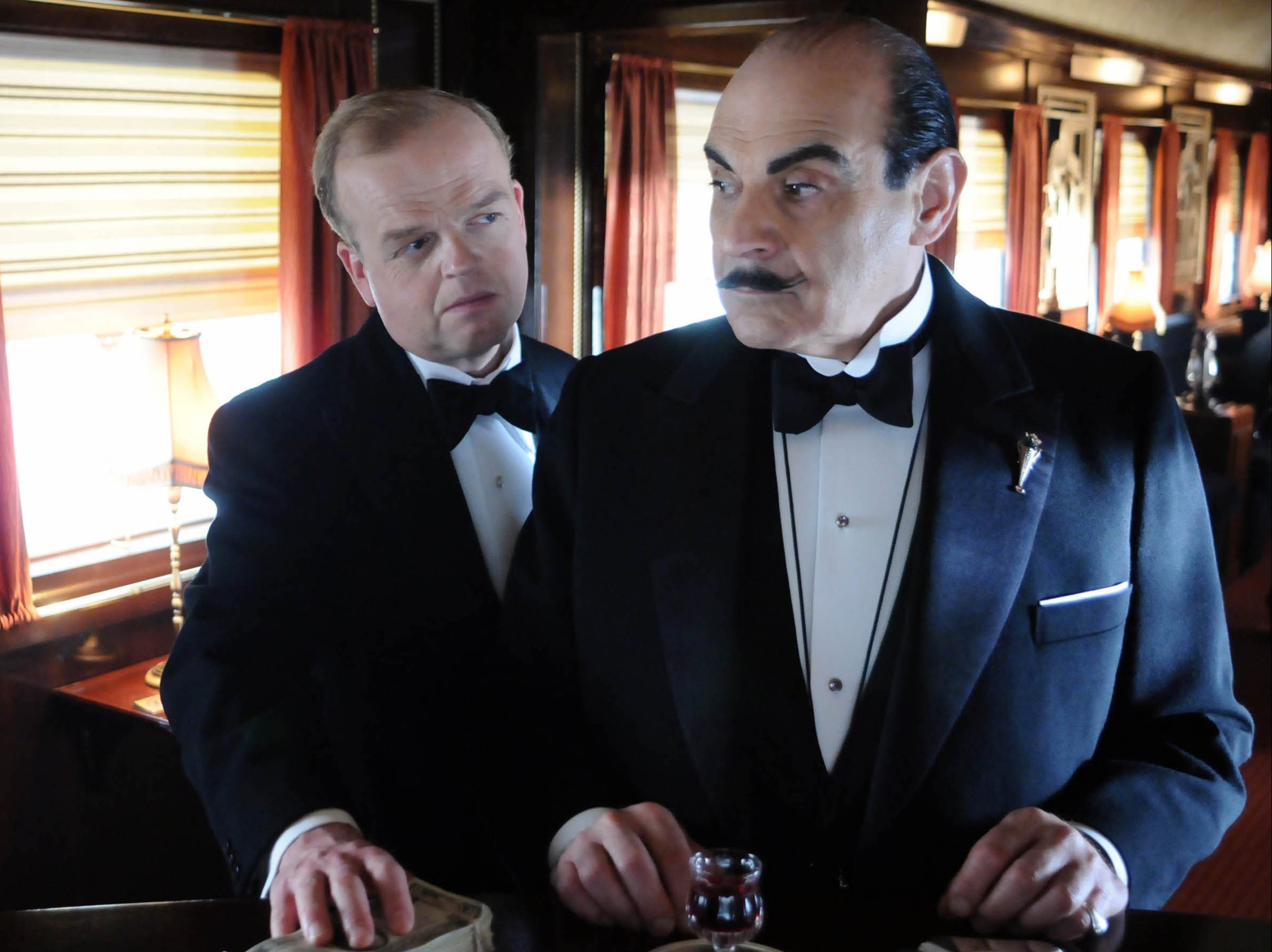 David Suchet as Poirot with Toby Jones, behind, as Samuel Ratchett in Agatha Christie’s Poirot: Murder on the Orient Express