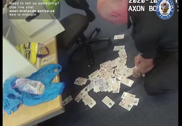 Officers react with surprise as £30,000 of cash floods from safe seized in fast food restaurant car park