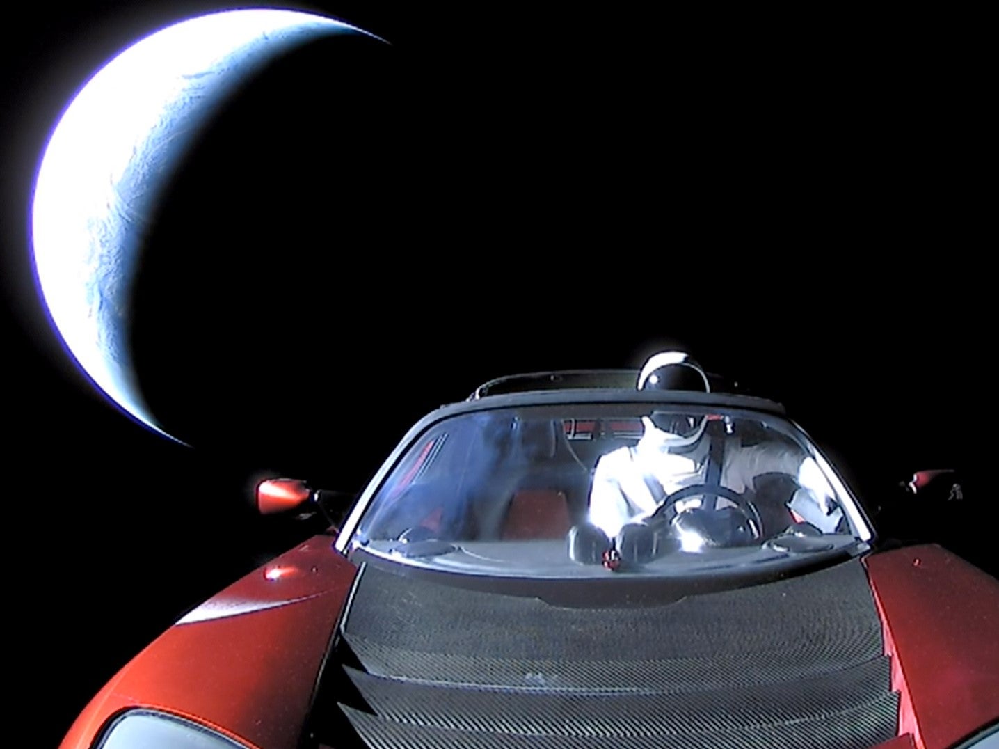 A Tesla roadster launched from the Falcon Heavy rocket with a dummy driver named ‘Starman’ heads towards Mars